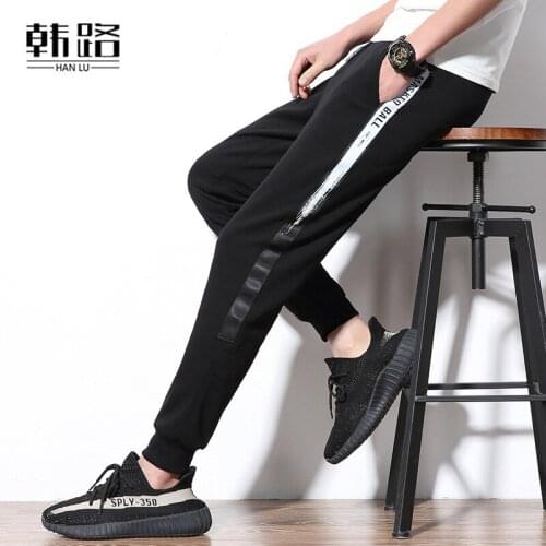 Fashion mens Sweatpants Spring autumn mens Side silver ribbon Pencil pants male Waist tether loose hip hop Beam foot trousers
