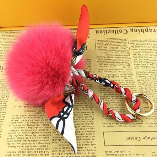 Brand luxury big pom pom ribbon fox fur designer bag charms cute furry ball pink keychains for women novelty gifts suppliers
