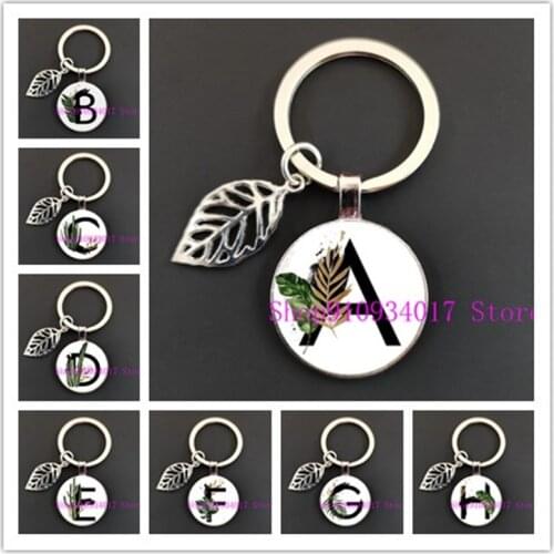 A-Z green leaf English alphabet round glass keychain new 26 letters handmade round glass keychain men and women car keychain