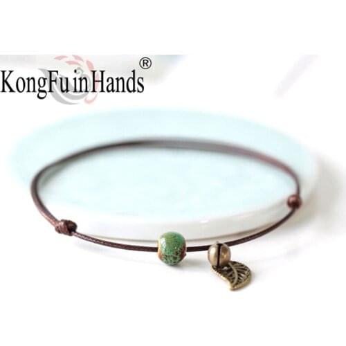 Wholesale Simple Ceramic Beads Ladies Original Handmade Fashion Coffee Braided Rope Hollow Leaf Pattern Bracelet Bell Jewelry