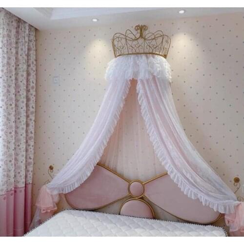 Gold and white mosquito net adorns the crown shelf