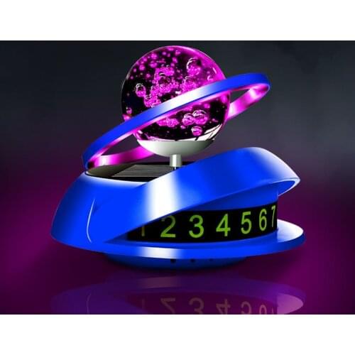 Solar car solid perfume seat planet rotating double ring suspension car decoration with atmosphere light luminous parking number