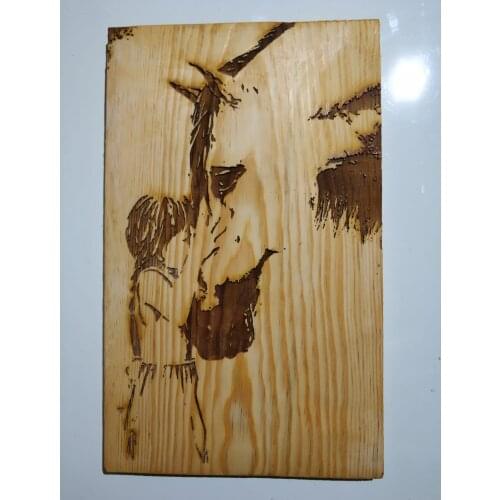 Birch plate being burned by laser on processed Beats and my daughter themed drawing