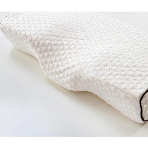 Butterfly-shaped memory foam prevents snoring sleep pillows and elastic neck protection fatigue massage pillow on the bed