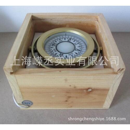 Wooden yacht with a magnetic compass