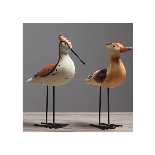 Scandinavian wooden birds are decorated in the living room window display