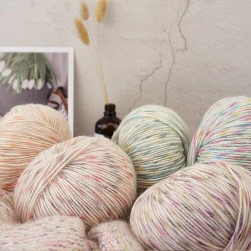 Hand DIY knitting of baby colored dot hook and stick needle sweater fancy yarn with medium and fine cotton yarn