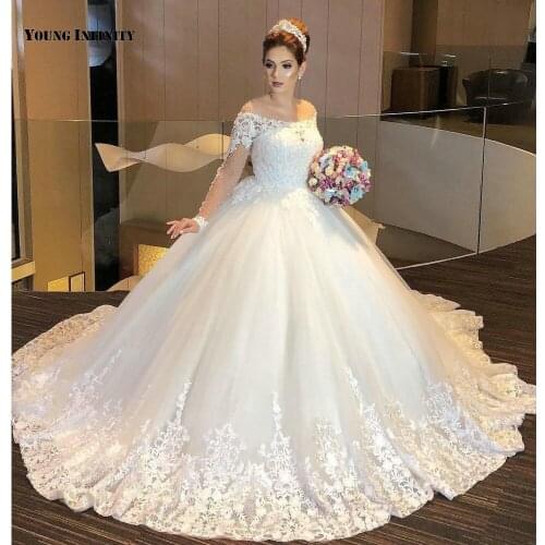 In Fashion Ball Gown Wedding Dresses 2021 Long Sleeves Bridal Gown Button Back Scoop Cathedral Train White Beaded Plus Size
