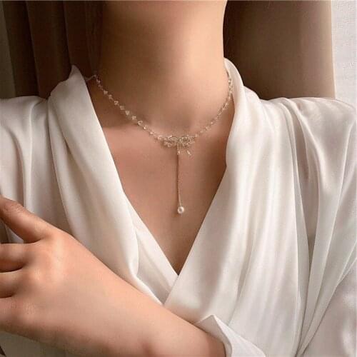 U-Magical Trendy Transparent Irregular Crystal Bowknot Tassel Pendant Necklace for Women Gold Metal Faux Pearl Necklace Jewelry