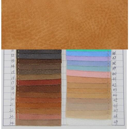 Luxury faux leather fabric wholesale Semi PU big Litchi embossed faux black leather fabric fake leather belt material