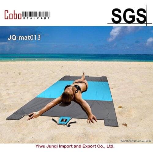 Beach Blanket 7' x 9' Oversized Sand Proof Picnic Mat for Traveling Hiking Camping and Festivals with 4 Stakes 4 Corner Pockets