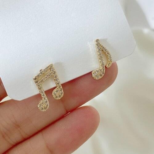 ZHOUYANG Unusual Womens Stud Earrings Music Note Small Gold Color Zircon Fashion Asymmetric Ear Jewelry Kpop Wholesale KAE067