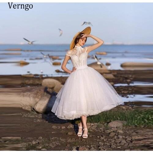 Verngo 2021 Modest Lace Short Cap Sleeves Wedding Dresses High Neck Bow Tie Bottons Tulle Tea Length Beach Garden Bridal Gowns