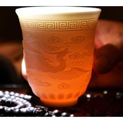 Dehua White Porcelain Tea Master Cup Kung Fu Cup Ceramic Relief Dragon and Phoenix Appear, Auspicious Qi