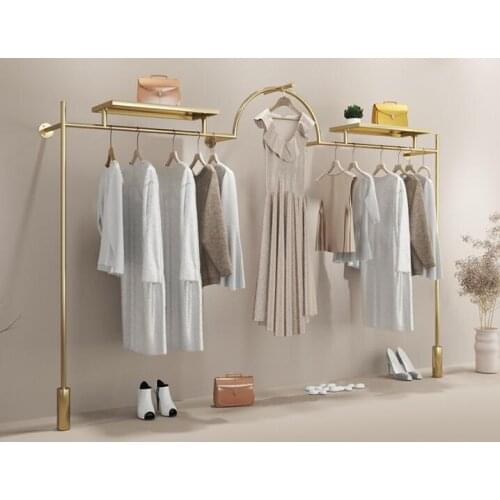 Stainless steel and titanium clothes shelf hanging on the wall of clothing store display shelf