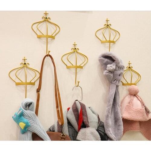 Golden crown hook combination hanging on the wall of dress shop