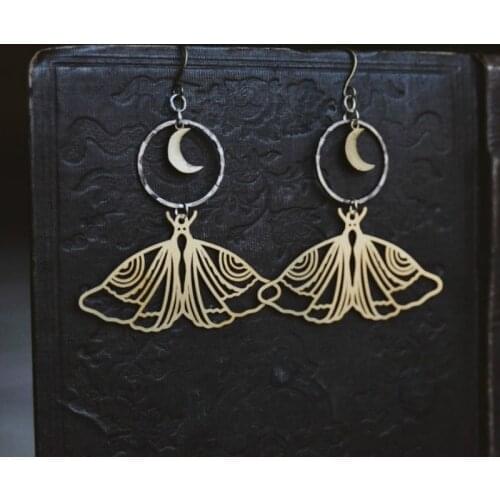 Night fauna. a pair of boho moon and moth cutout mixed metal earrings