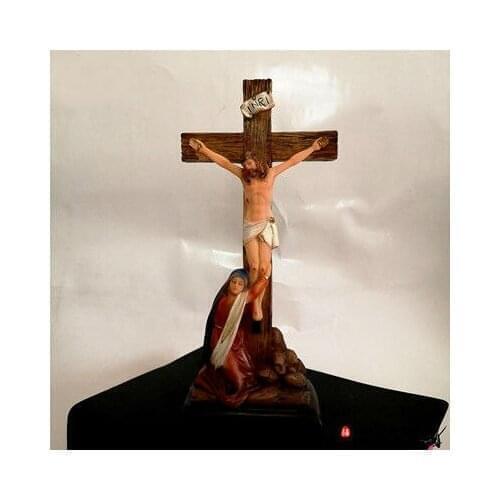 Catholic sacred object, the Virgin Kneeling on the cross the resin statue of Jesus and Mary on the table