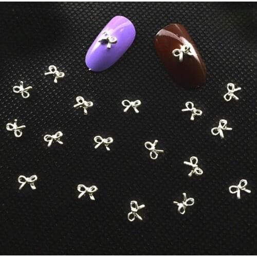 100pcs Manicure Silver Bows 3D Nail Art Decoration,Alloy Nail Charms, Nails Glitter Rhinestones Nail Supplie Fashion Tie Fingers