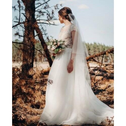 Wedding Dress A-Line O-Neck Cap Sleeve Lace Appliques Sequined Pearls Button Back Floor Length Sweep Train Elegant Bride Gown