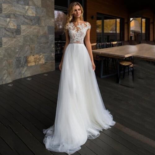 2021 New Arrival Cheap Wedding Dresses Cap Sleeve Lace Bride Dress A Line Women Buttons Illusion Back Beach Wedding Gowns