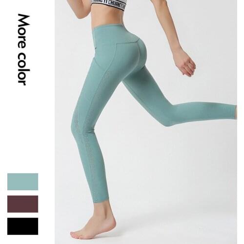 2021 New Nylon Nude Side Pocket Yoga Pants Female Hollow Stitching Hip-lifting Tight-fitting Sports Running Fitness Pants