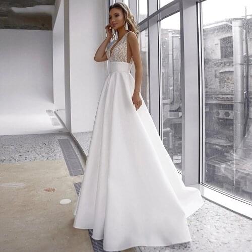 Elegant Deep V Neck Glitter Beaded Illusion Tulle Bridal Gowns YIWUMENSA Sexy Backless Satin A Line Wedding Dresses Sleeveless