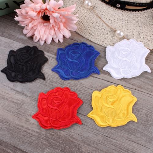 Roning patching putting on clothes putting on childrens clothing accessories placing big roses and colorful roses