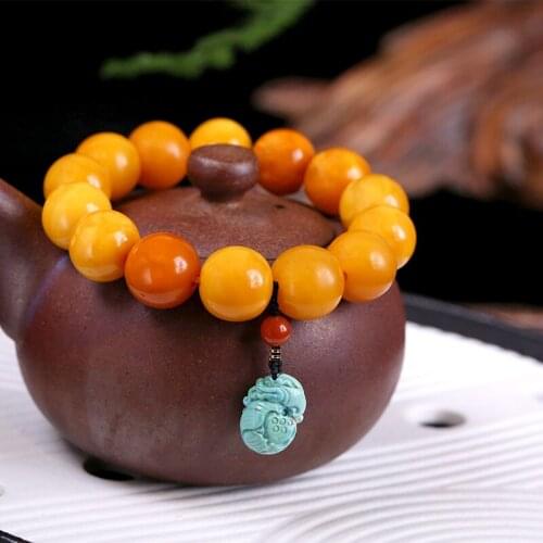 As pure authentic old wax cake acura honey amber with hand chain live west Asian men and women hand string