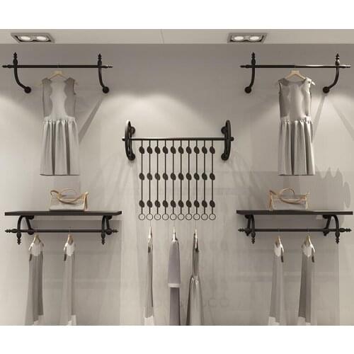 Clothes hangers. Display rack. Wall hangers. Men and womens sides. Childrens clothes rack black.060
