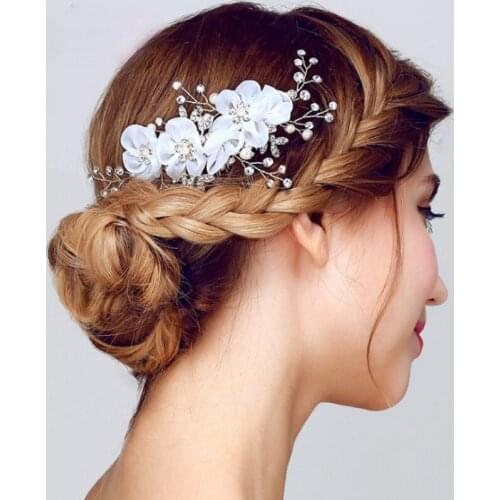 The cherry blossoms are decorated with white and red hair accessories and accessories for the brides hair