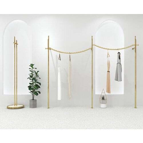 Wall mounted stainless steel champagne gold clothes rack in clothing store