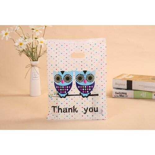 100psc Handbag clothing plastic handbag bag hand bag four finger bag clothing store bag