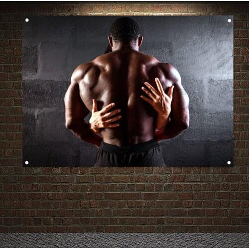African American Male Athlete Posing Demonstrating Muscular Development WithThe Hands Of A Girl On, Banners Flags Tapestry Mural