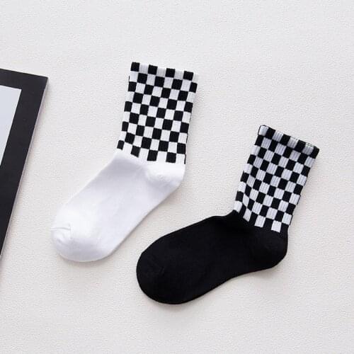 A pair of street style cotton socks novelty white and black square skateboard socks chic Harajuku checkerboard hip hop socks