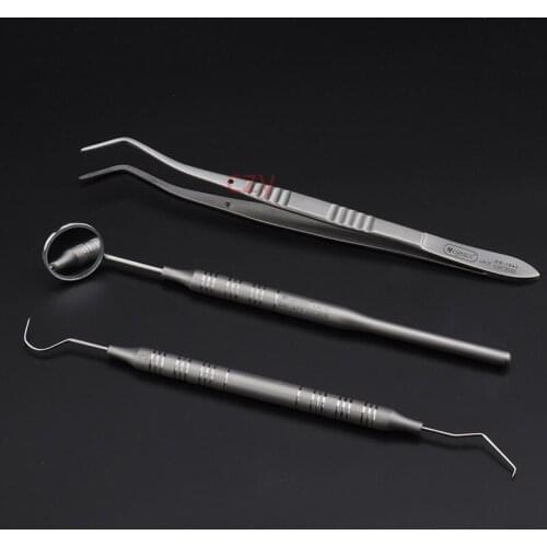 Dental tools commonly used to check three-piece mouth mirror probe curved tweezers teeth cleaning dental equipment equipment mat