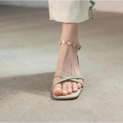 Fairy leather word belt sandals female summer flat bottom 2021 new low-heeled pearl chain sexy Roman shoes